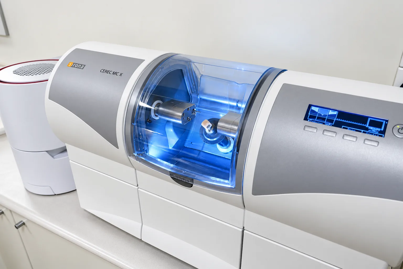 The CEREC milling unit at Park Road Dental, with a ceramic block being shaped inside its chamber